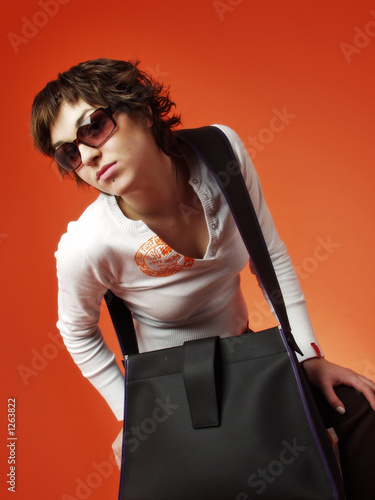 model with glasses and bag