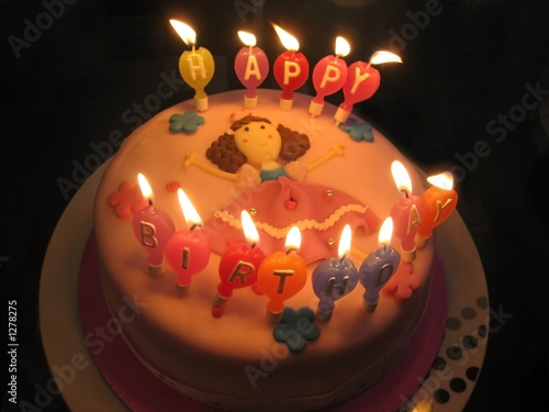 pink birthday cake with candles