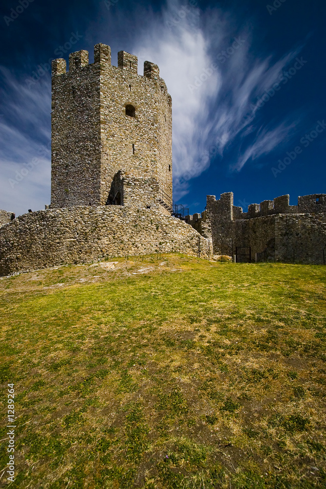 medieval castle with deep blue sky and clouds