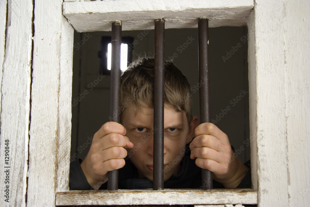 Obraz premium rowdy behind ancient prison bars