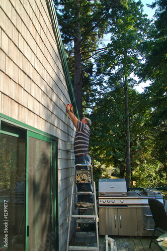 man working on house
