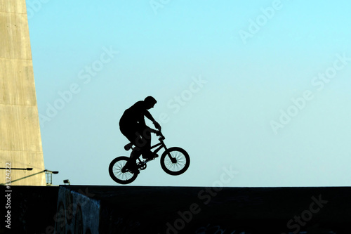 young jumping with bicycle