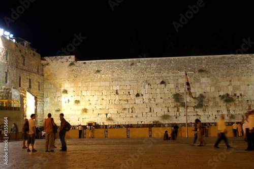 People standing at wailing wall in Jerusalem at night