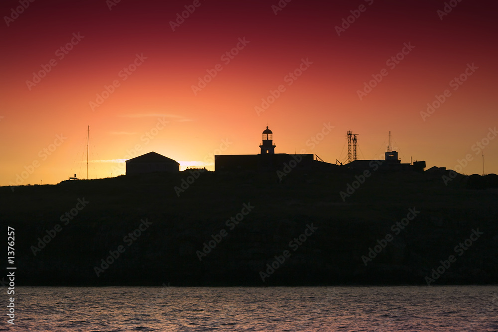 silhouette of an island and lighthouse