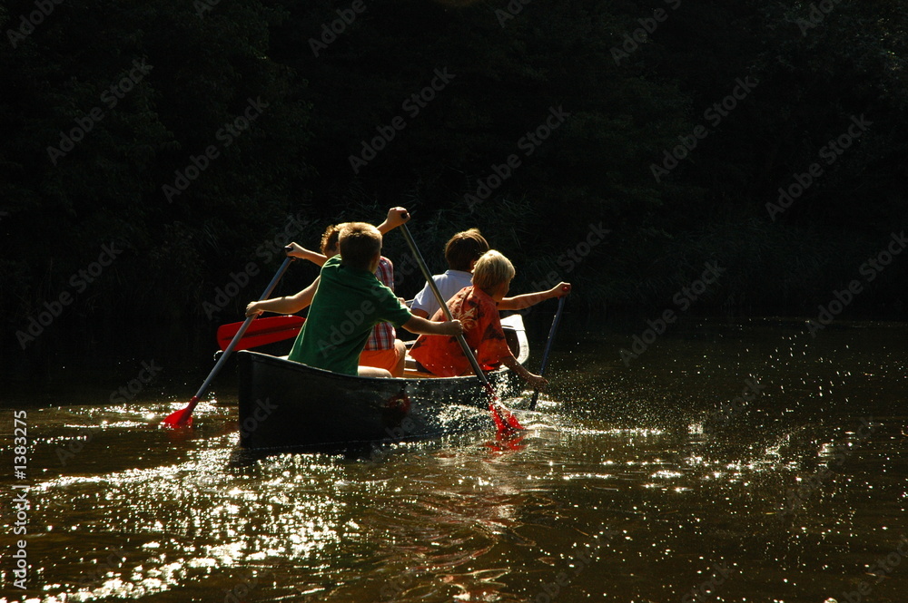 four boys in  canoe