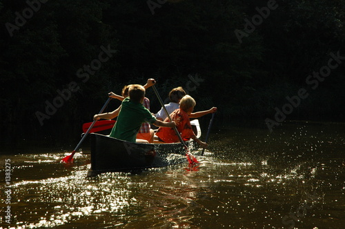 four boys in  canoe
