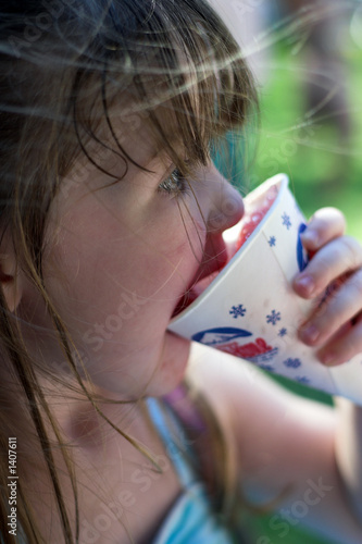 young girl eating a snow cone