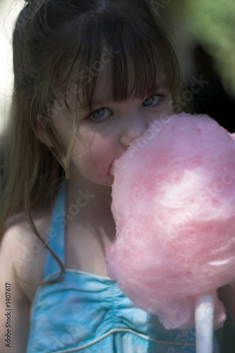 young girl eating cotton candy