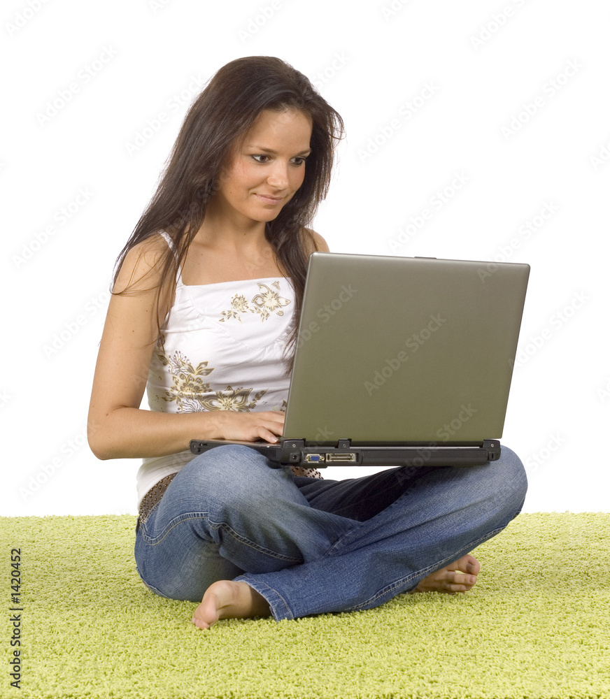 Naklejka premium young woman with laptop on the green carpet