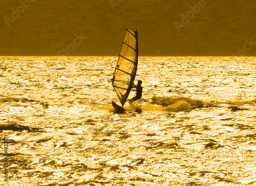 lone windsurfer at sunset