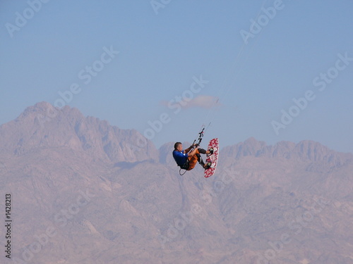 kitesurfer above mountains