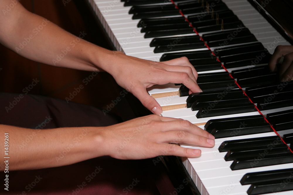 Fototapeta premium hands playing piano keys