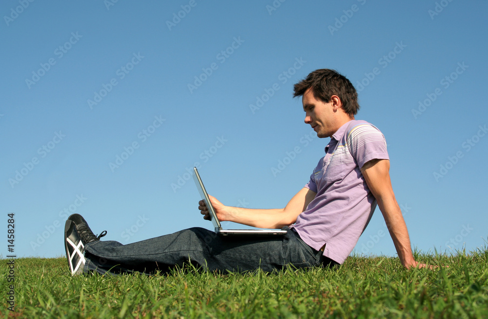 man using a laptop outdoors