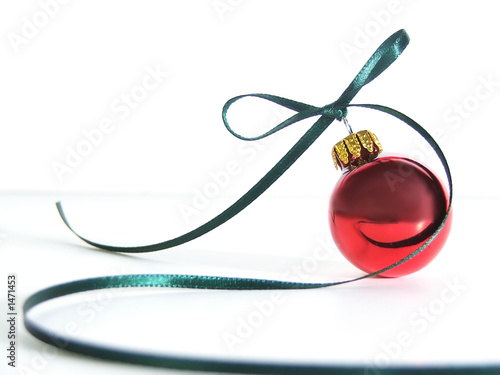 red ornament with swirling ribbon