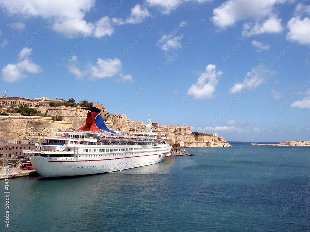ship off the coast of malta with ocean and clouds