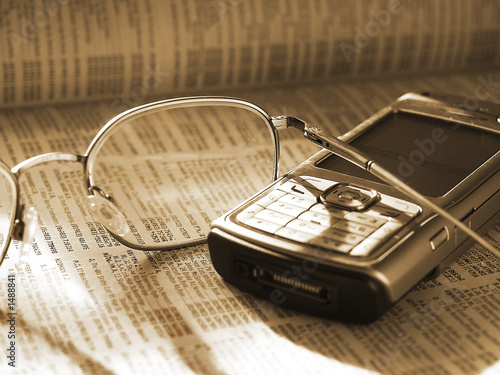 mobile phone and glasses on phone directory