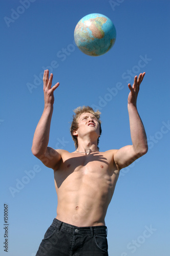 young muscular man playing with a globe © Vladimir Wrangel