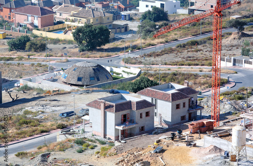 aerial view of construction site, villas and cranes