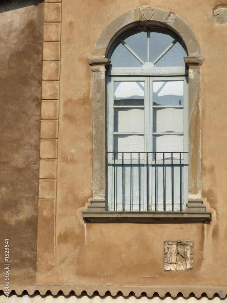 decorative window on a brown wall