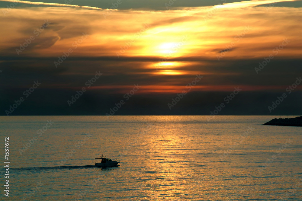recreation boat sailing at sunset recreation boat sailing at sunset