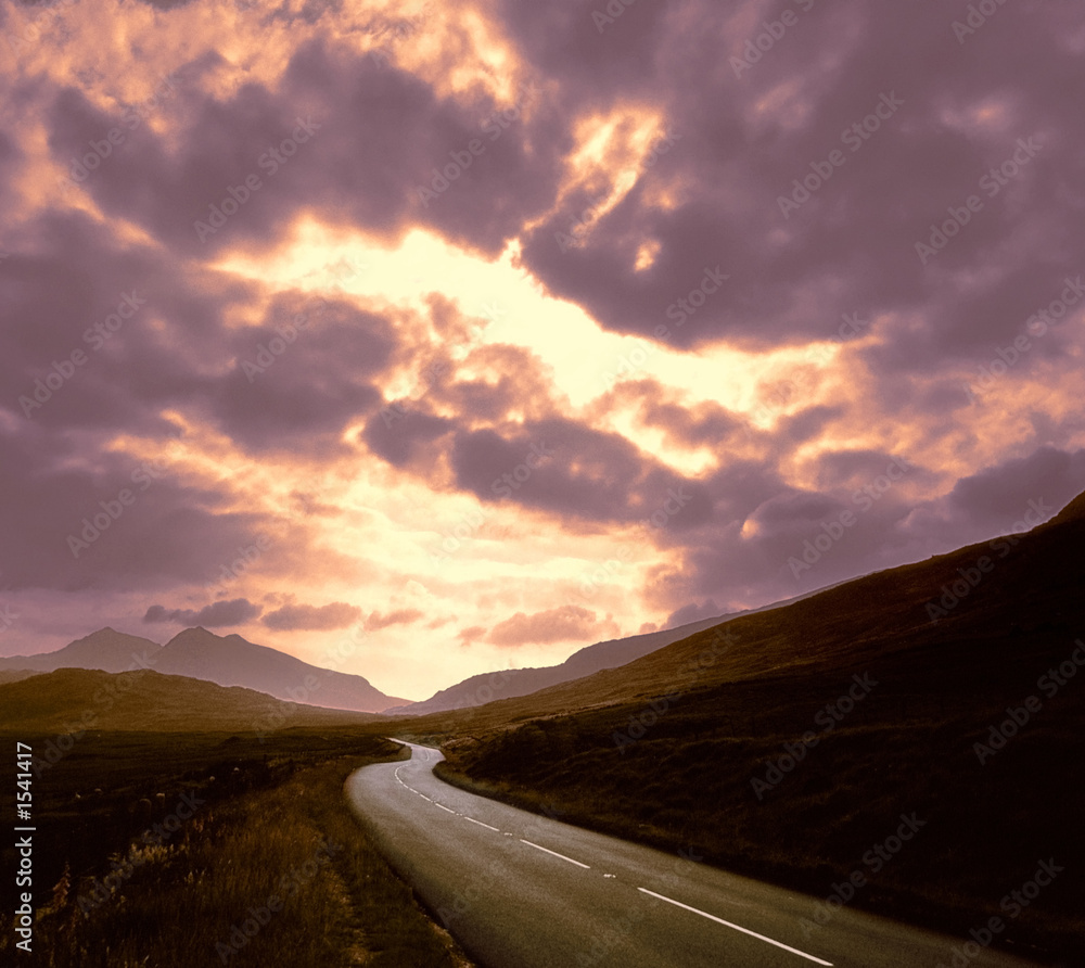 road through mountains sunset sky