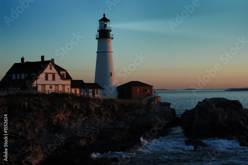 lighthouse shining at dawn