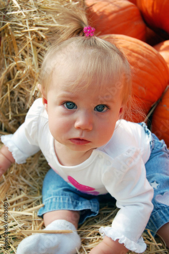 baby in pumpkin patch
