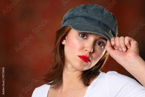 brunette with cap red backdrop