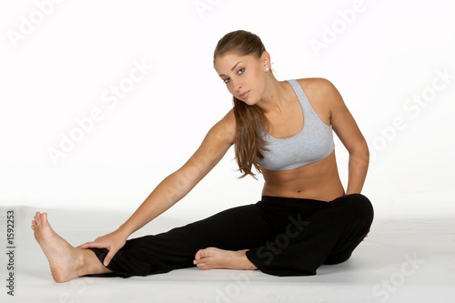 woman stretching leg in workout attire