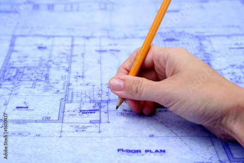 contractor marking blueprints