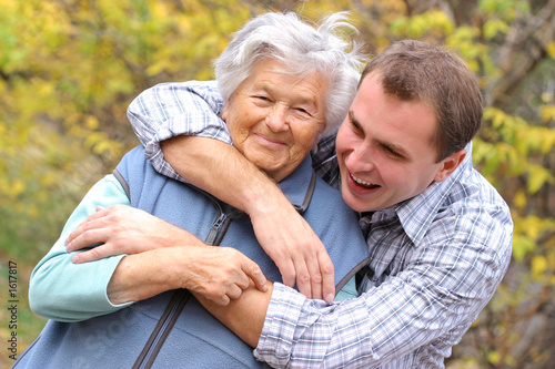 Tablou canvas young man hugs elderly woman