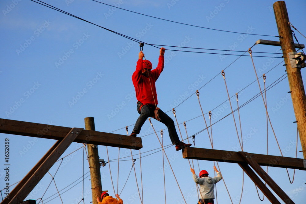courageous man hanging on a steel wire Stock Photo