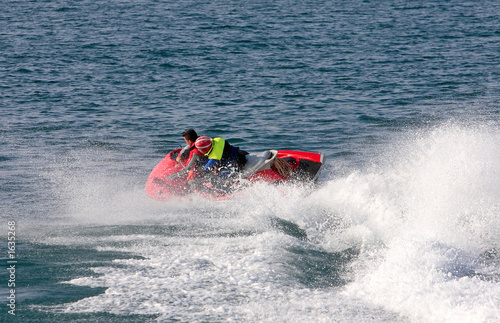 young couple speeding on board a large rescue jetbike