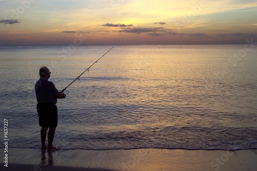 lone fisherman at sunset
