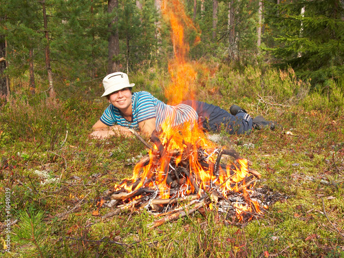 happy young woman and campfire
