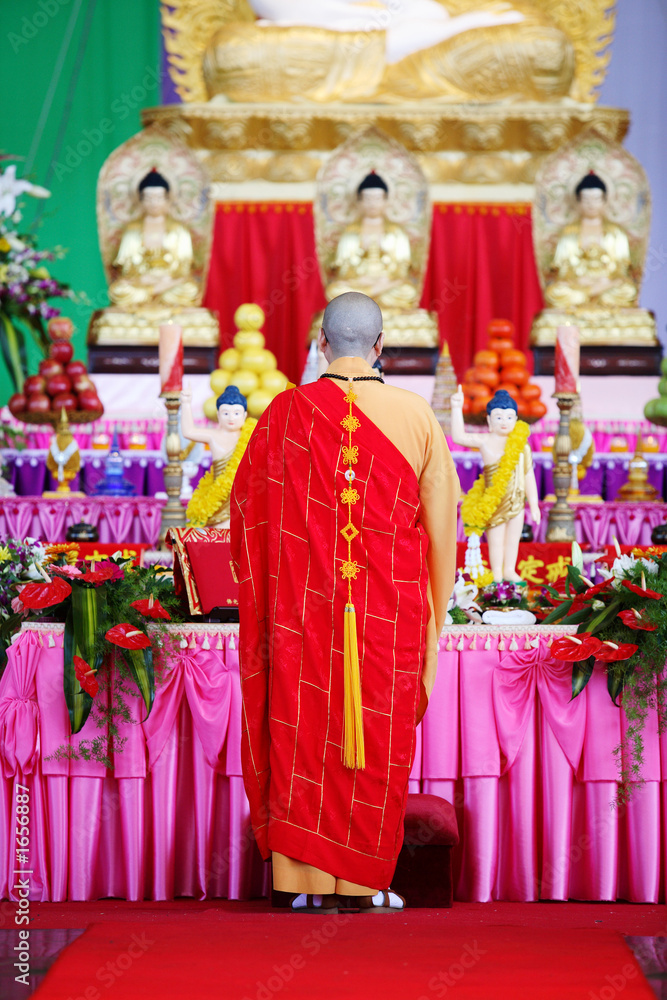 monk with budha statues monk with budha statues