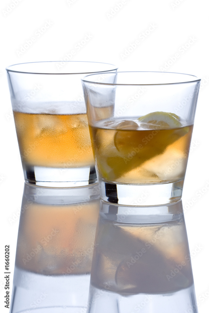 two whiskey glasses against white background two whiskey glasses against white background
