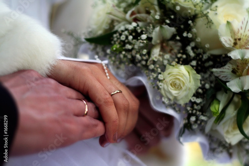 just married. hands with rings and wedding bouquet.