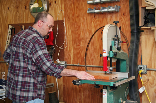 a woodworker cutting a board