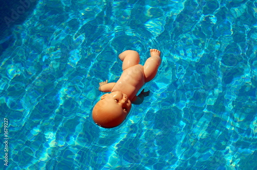 baby doll on swimming pool photo