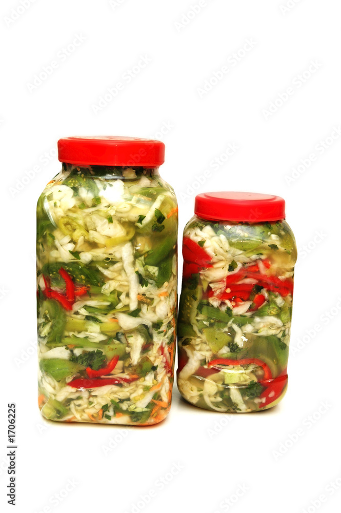 two jars with pickles isolated on white two jars with pickles isolated on white