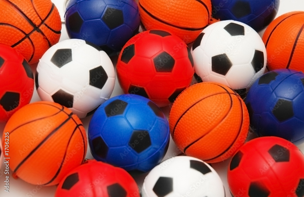 selection of basketballs and footballs