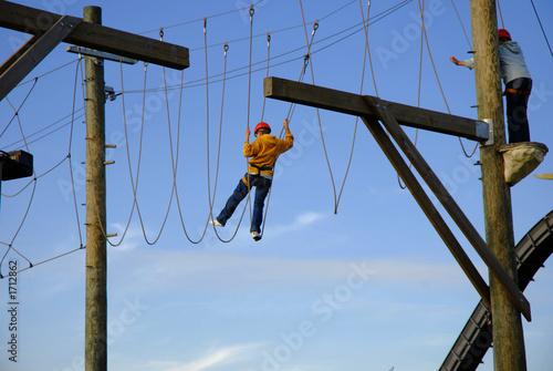 courageous boys hanging high above the ground