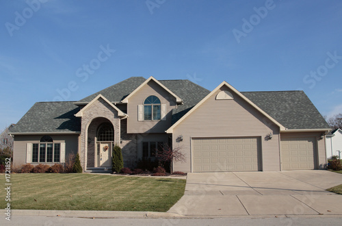 vinyl sided home with brick entrance