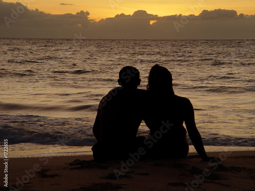 couple on the beach watching sunset  romatic date on island