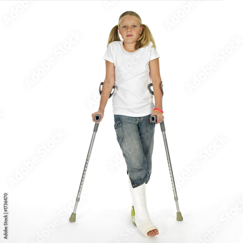 girl with a broken leg walking on crutches