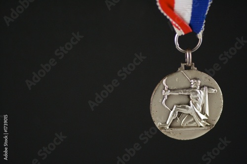 medal with archer and black background