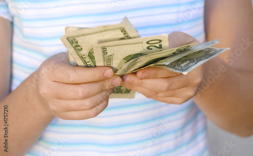 child counting money (shallow dof)