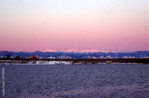 winter sunrise in denver with a lake and mountains © John De Bord