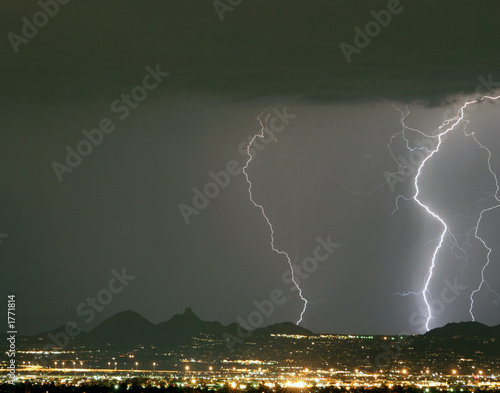 lightning storm over the city lights